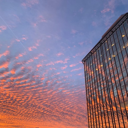 Vivid sunrise reflected off and office building